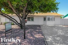 Phoenix house for rent - a white house with a tree and a mailbox