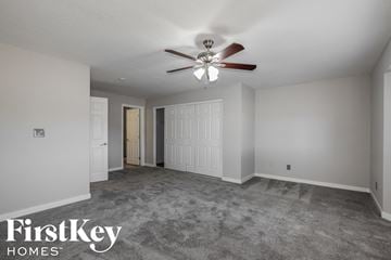 Phoenix house for rent - a living room with carpet and a ceiling fan