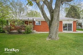 Indianapolis house for rent - A red brick house with a tree in front of it.