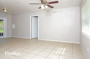 Port Charlotte house for rent - A room with a ceiling fan and a door.