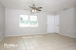 Port Charlotte house for rent - A room with a fan, tiled floor, and a window.