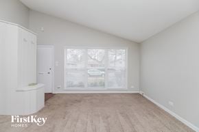 Dolton house for rent - a spacious living room with a large window and white cabinets