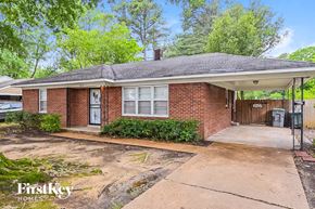 Memphis house for rent - a small brick house with a porch and a driveway