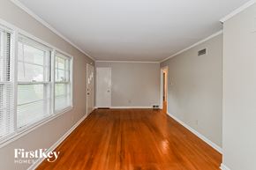 Memphis house for rent - an empty living room with wood floors and a large window