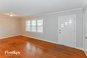 Memphis house for rent - a living room with a wooden floor and a white door