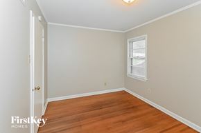 Memphis house for rent - an empty bedroom with wood floors and a window
