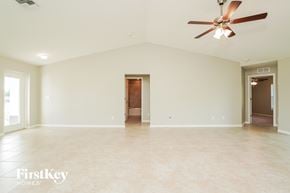 Cape Coral house for rent - a large empty living room with a ceiling fan