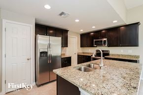 Cape Coral house for rent - a kitchen with granite counter tops and stainless steel appliances