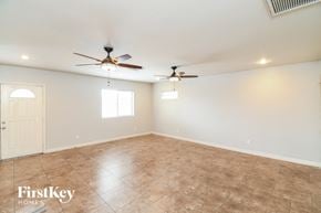 Mesa house for rent - A room with a ceiling fan and a door.