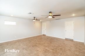 Mesa house for rent - A spacious room with a ceiling fan and tiled floor.