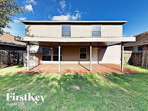 Cypress house for rent - a house with a porch and a grass yard