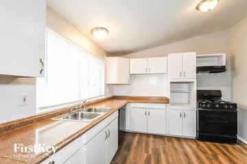 Florissant house for rent - A kitchen with white cabinets and a wooden counter top.