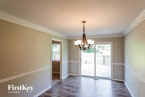 Birmingham house for rent - a dining room with a chandelier and a door to a deck