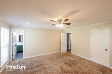 Birmingham house for rent - a living room with carpet and a ceiling fan
