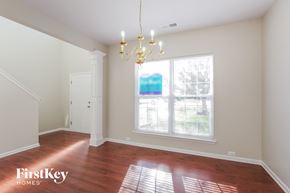 Charlotte house for rent - an empty dining room with a large window and a chandelier