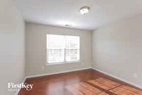 Charlotte house for rent - a living room with wood floors and a large window