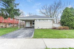 Dolton house for rent - a white brick home with a driveway and a red house