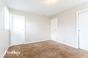 Dolton house for rent - a bedroom with white walls and carpet and two doors