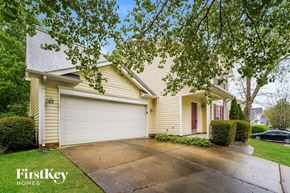 Huntersville house for rent - a yellow house with a driveway and a white garage door