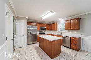 Huntersville house for rent - a kitchen with wooden cabinets and stainless steel appliances