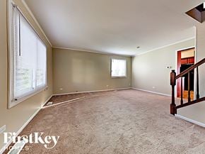 Aurora house for rent - A room with a carpeted floor and a window with blinds.