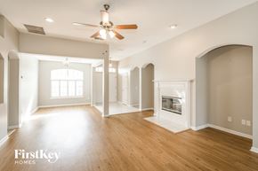 Fleming Island house for rent - A spacious living room with wood floors and a fireplace.