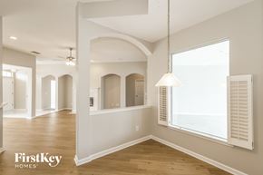 Fleming Island house for rent - A well-lit, spacious room with wooden floors and arched doorways.