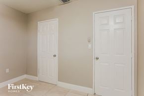 Hollywood house for rent - a bedroom with two white doors and a tiled floor