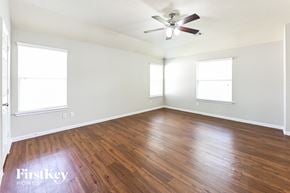 Houston house for rent - a living room with wood floors and a ceiling fan