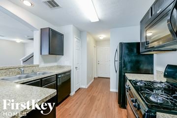 Houston house for rent - a kitchen with a stove and a refrigerator and a sink