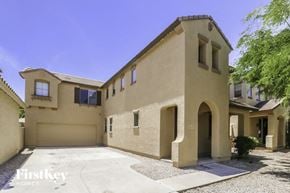Surprise house for rent - a big house with a driveway and a tree