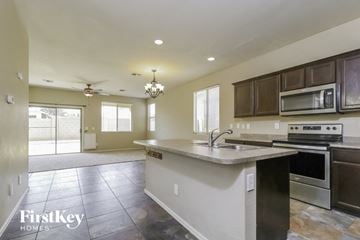 Surprise house for rent - a kitchen with a sink and a stove and a microwave