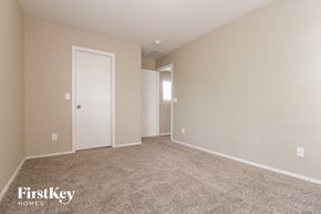 Surprise house for rent - a bedroom with carpet and a door to a closet