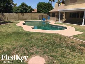 Phoenix house for rent - a backyard with a swimming pool and a house