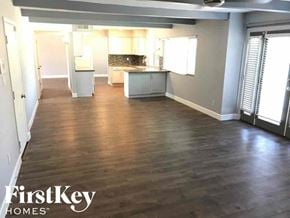Phoenix house for rent - an empty living room and kitchen with wood floors