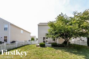 Noblesville house for rent - A tree in a grassy area in front of a house.
