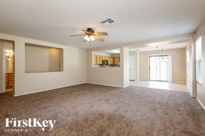 Surprise house for rent - A spacious room with a carpeted floor and a ceiling fan.