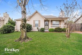 Cordova house for rent - a home with a lawn and a tree in front of it