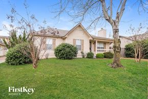Cordova house for rent - a home with a lawn and a tree