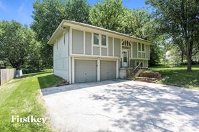 Belton house for rent - a white house with a driveway and a garage door