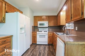 Belton house for rent - a kitchen with white appliances and wooden cabinets