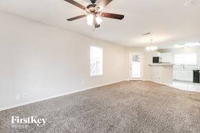 Houston house for rent - A spacious room with a carpeted floor and a ceiling fan.