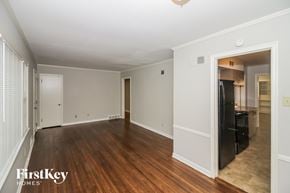 Memphis house for rent - an empty living room with wood flooring and white walls