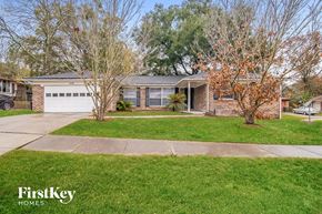 Jacksonville house for rent - a brick house with a lawn and a white garage door