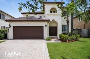 Miami house for rent - A house with a brown garage door is for sale.