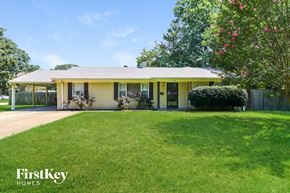 Memphis house for rent - a small yellow house with a lawn and a fence