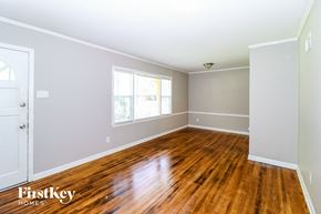 Memphis house for rent - the living room of a house with wooden floors and a window