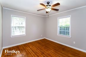 Memphis house for rent - a bedroom with wood floors and a ceiling fan
