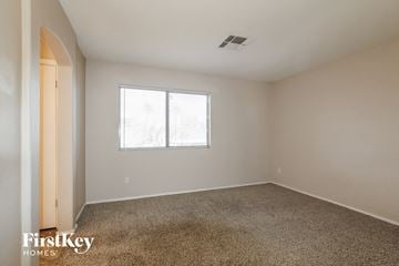 Surprise house for rent - the living room of an apartment with carpet and a window
