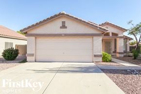 Surprise house for rent - a home with a white garage door and a driveway